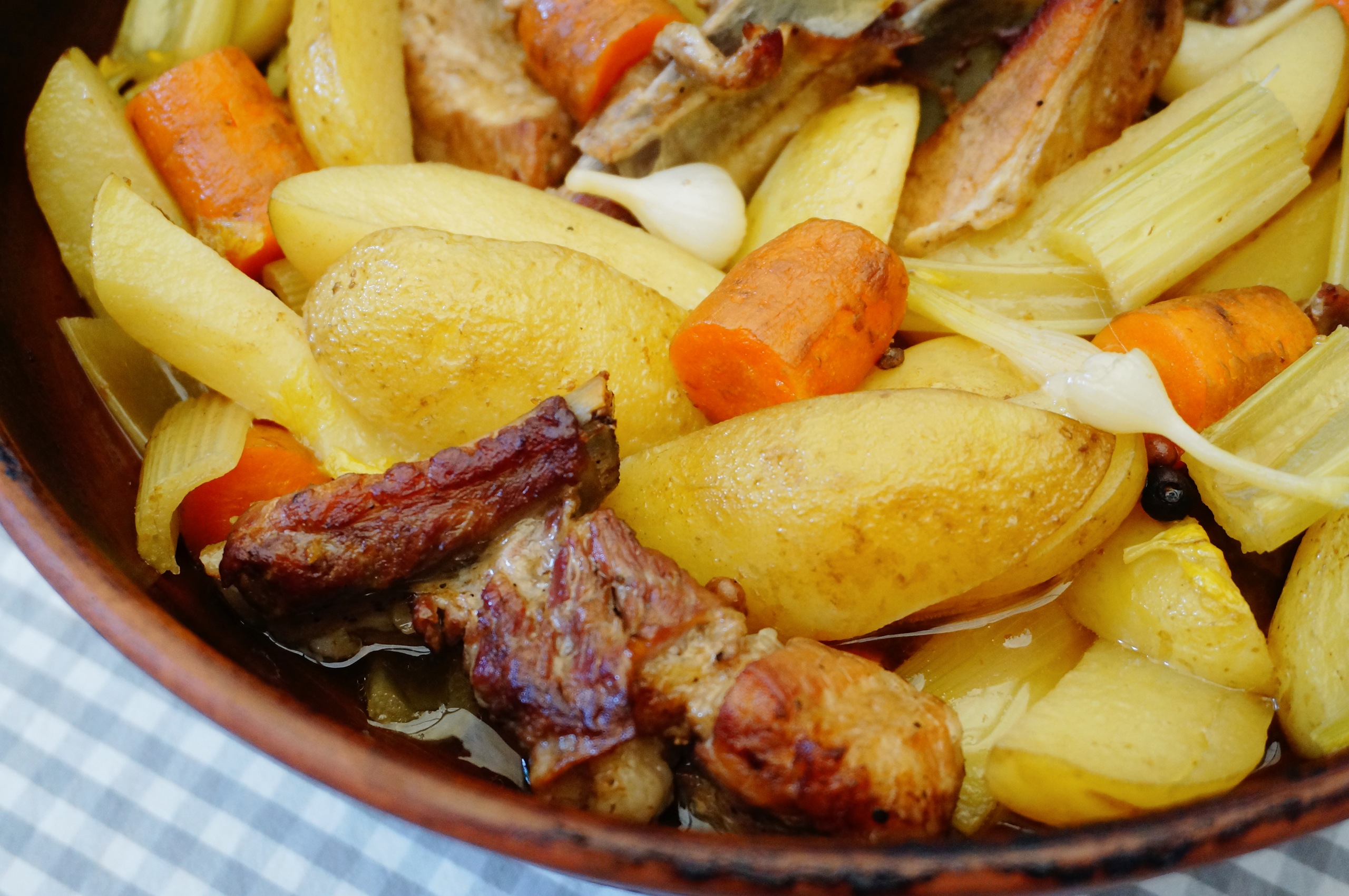 Свиные ребрышки, картофель, морковь и сельдерей в готовом айнтопфе крупным планом