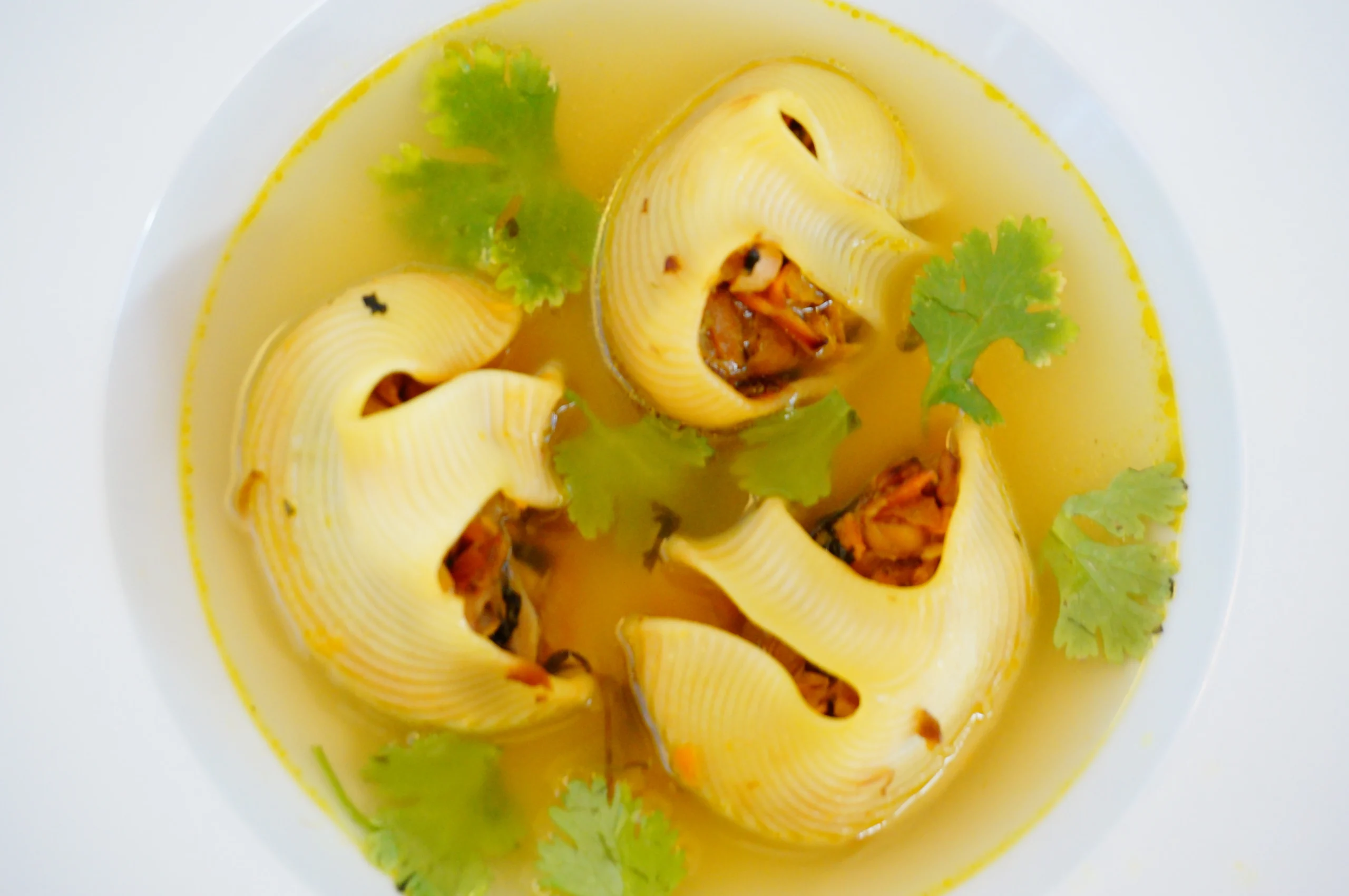 Лумакони с овощной начинкой в сырном бульоне, вид сверху